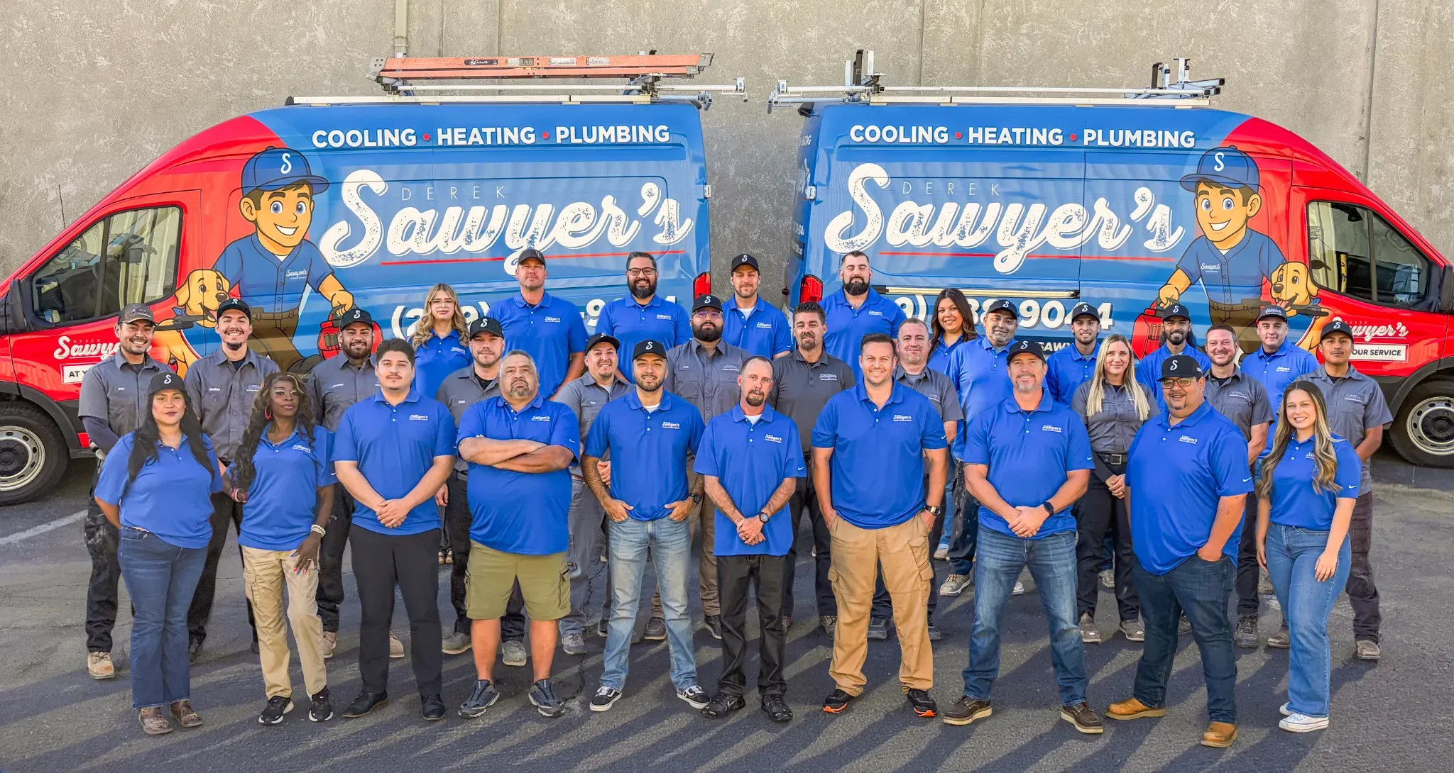 Derek Sawyer's team gathered in front of two branded service vans